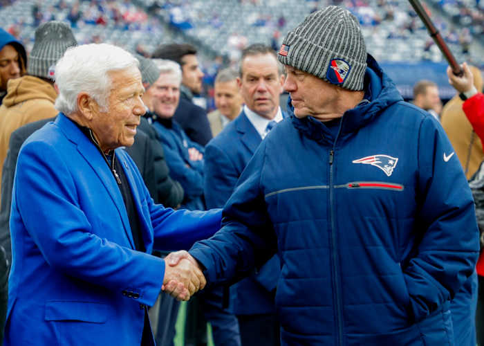 New England Patriots owner Robert Kraft (left) shares a pregame handshake with coach Bill Belichick.